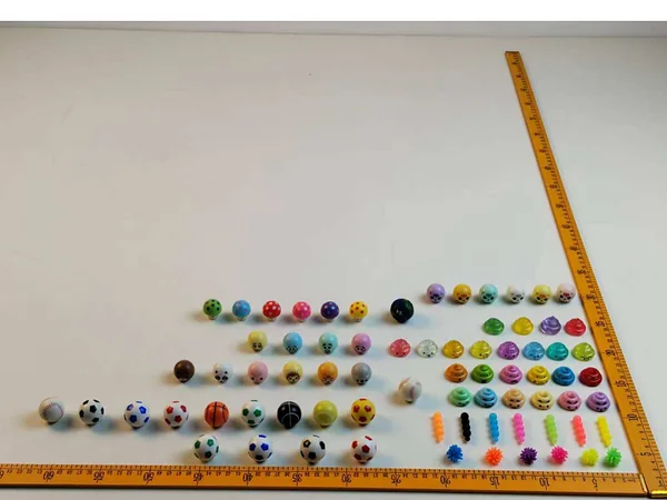 Capsule toy miniature assortment with a measuring ruler