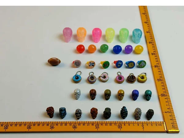 Miniature bouncing balls, charms and capsule novelties